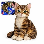 A cozy tabby cat is peacefully napping on a colorful holiday-themed blanket while resting its head on a tattooed arm, creating a warm and snug moment of friendship.