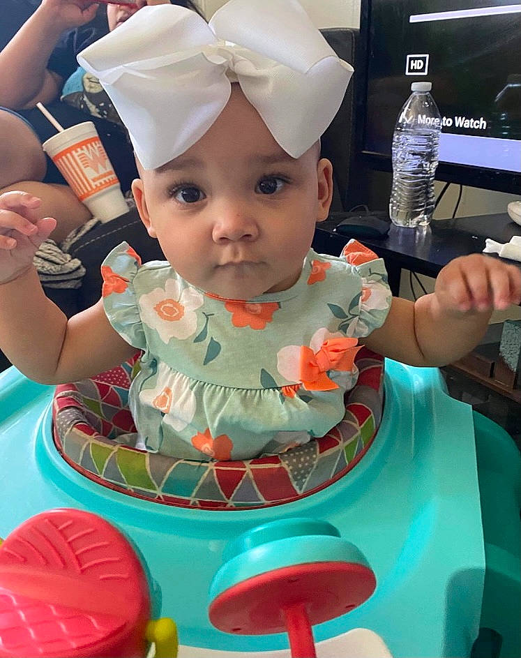 Laurel is registered to the contest to win money with this photo: arm, baby, baby_toddler_clothing, birthday, bottle, cake, cake_decorating, cake_decorating_supply, chair, facial_expression, food, happy, headwear, icing, party_supply, person, pink, skin, sugar_cake, sugar_paste