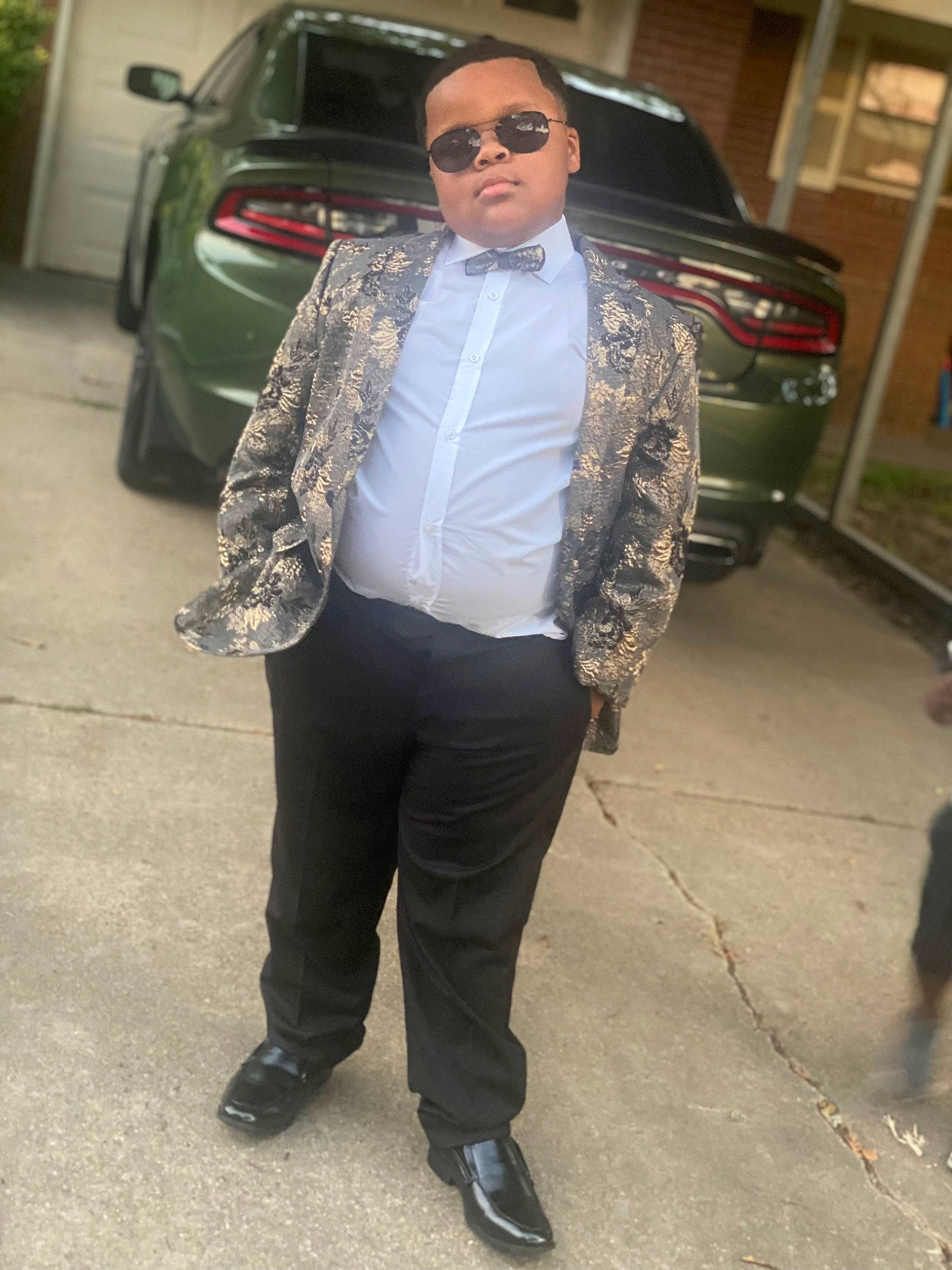 Jermaine joined the competition — help win amazing prizes! asphalt, automotive_design, beard, blazer, car, dress_shirt, eyewear, facial_hair, fashion_design, formal_wear, hair, land_vehicle, person, road, sunglasses, tire, vehicle, vehicle_registration_plate, vision_care, waist