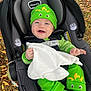 Jackson joined the competition — help win amazing prizes! baby, car_seat, green_clothing, dinosaur_hat, blanket, outdoor, autumn_leaves, smiling, infant, child, cute, seatbelt, happy, person, toy, grass, nature, fall, headwear, footwear