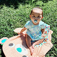 Valentina joined the competition — help win amazing prizes! baby, blanket, child, colorful, cute, daylight, face, grass, greenery, happy, infant, nature, outdoor, pacifier, patterned_clothing, playtime, portrait, sitting, summer, sunlight