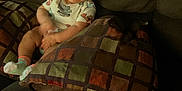 Valentina is registered to the contest to win money with this photo: baby, child, clothing, comfort, couch, cozy, cute, face, furniture, happy, home, indoor, infant, person, pillow, relaxing, sitting, smile, sock, young