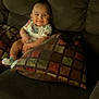 Valentina is registered to the contest to win money with this photo: baby, smile, couch, pillow, infant, child, indoor, sitting, clothing, sock, happy, face, furniture, home, cozy, cute, person, young, relaxing, comfort
