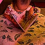baby, book, carpet, child, curious, cushion, elmo, floor, hand, head, indoor, leaf_pattern, onesie, pacifier, pink, play_gym, reading, seated, soft_toys, toy