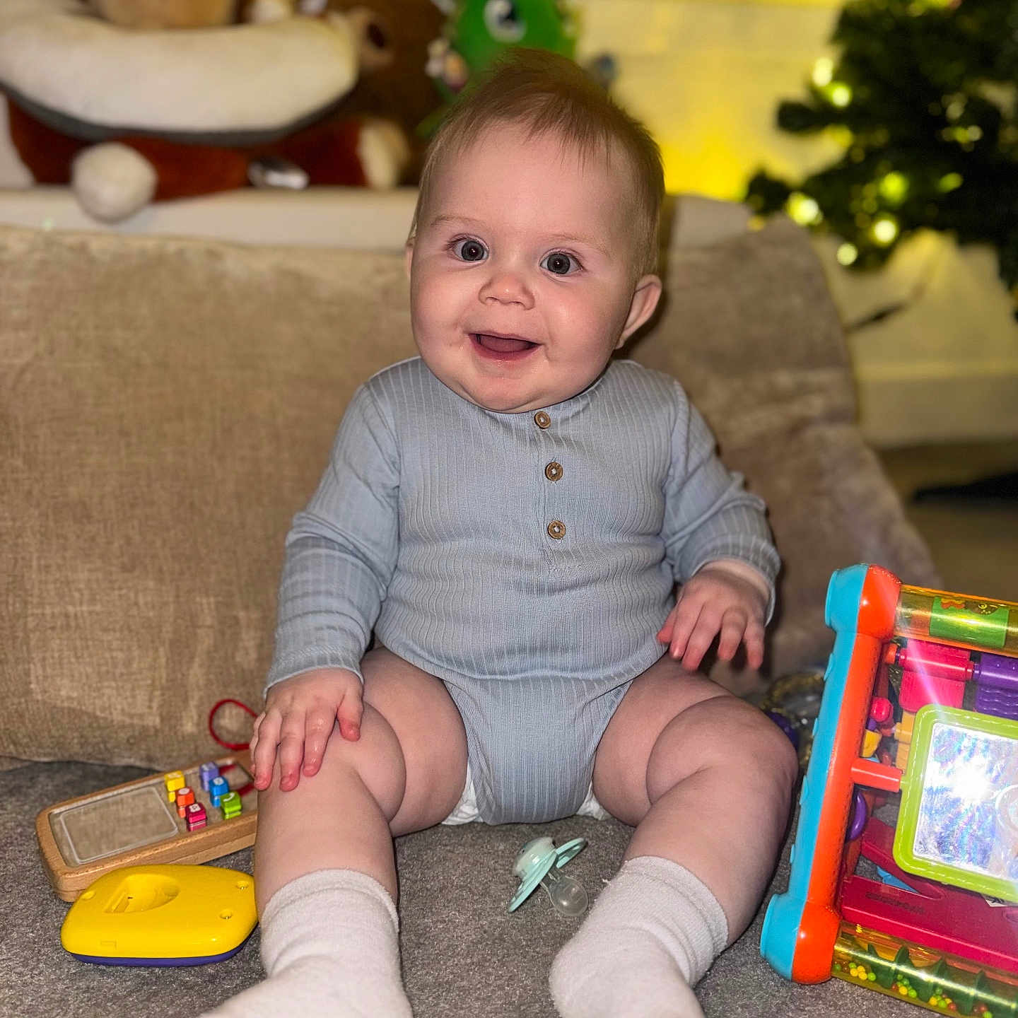 Nikodem joined the competition — help win amazing prizes! baby, carpet, child, colorful, cushion, cute, face, furniture, hand, happy, indoor, onesie, pacifier, playtime, plush, sitting, smiling, sock, soft, toy