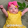 baby, child, infant, yellow_dress, pink_headband, flower, leaf, arms_up, cute, portrait, laying_down, outdoor, nature, soft_texture, daisy, headwear, smiling_face, human, closeup, toddler