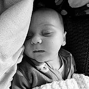 Adam participe au concours pour gagner de l'argent avec cette photo : baby, sleeping, blanket, pillow, cozy, infant, black_and_white, face, peaceful, soft_texture, closeup, portrait, child, indoors, resting, clothing, cute, toddler, nap, serene