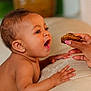Brielle joined the competition — help win amazing prizes! baby, child, hand, food, snack, earring, curious, skin, fingers, nails, couch, indoor, closeup, person, portrait, cute, expression, feeding, happy, young