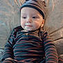Malachi joined the competition — help win amazing prizes! apparel, baby, blanket, child, comfort, cozy, cute, expression, face, hat, indoors, infant, portrait, relaxed, sitting, smiling, soft_light, striped_clothing, warm, young_child