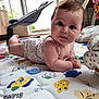 baby, infant, play_mat, cute, indoors, child, toy, colorful, face, expression, curious, lying_down, skin, hair, arm, floor, window, light, clothing, home