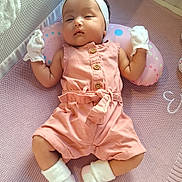 Emma joined the competition — help win amazing prizes! baby, infant, sleeping, pink, romper, mittens, headband, bow, blanket, sock, cozy, cute, child, indoor, soft, resting, newborn, person, laying, nursery