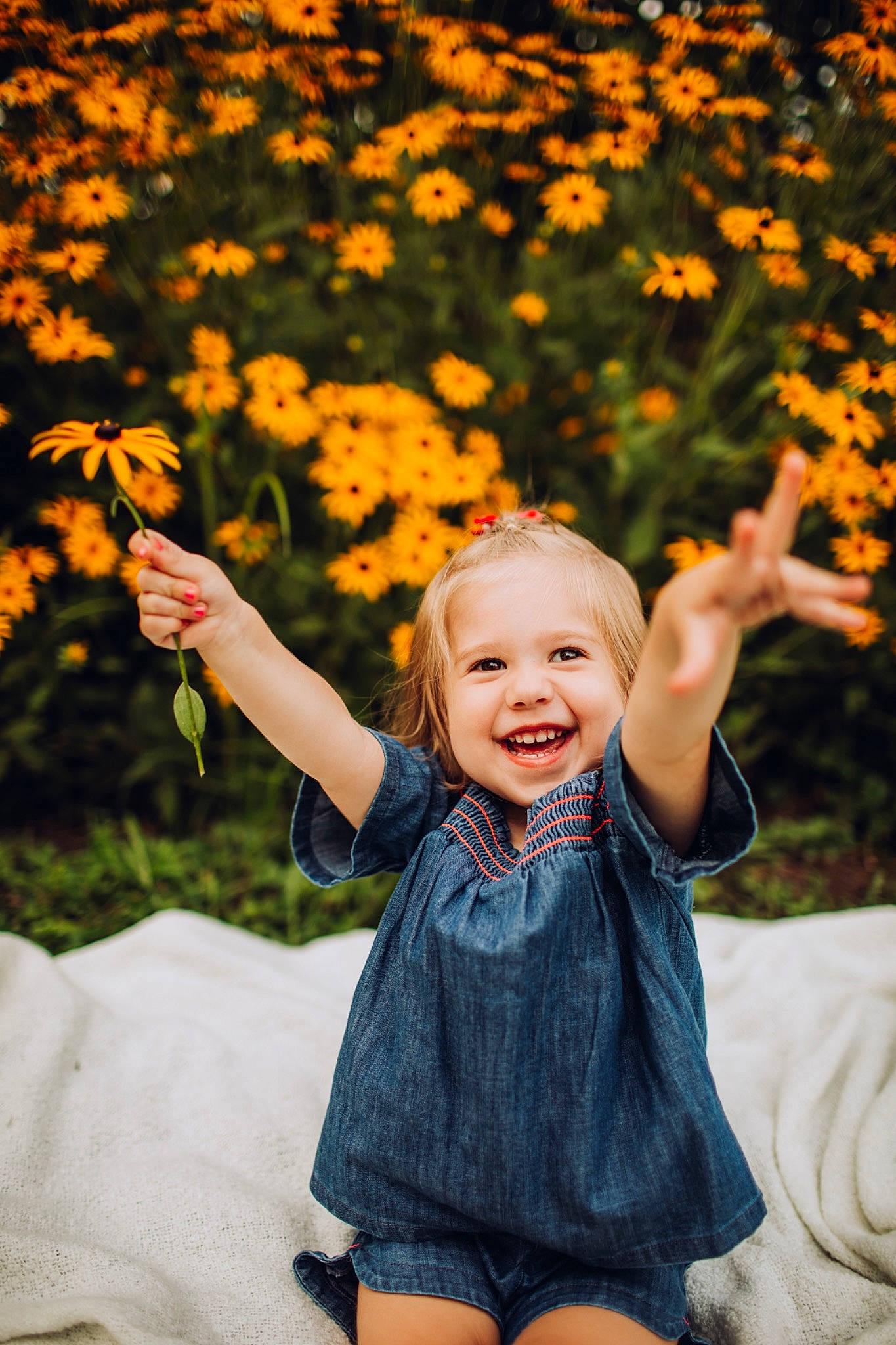 Blaire is registered to the contest to win money with this photo: autumn, child, child_model, facial_expression, finger, flower, fun, grass, happy, joy, leaf, orange, people, people_in_nature, person, photograph, photography, plant, smile, toddler