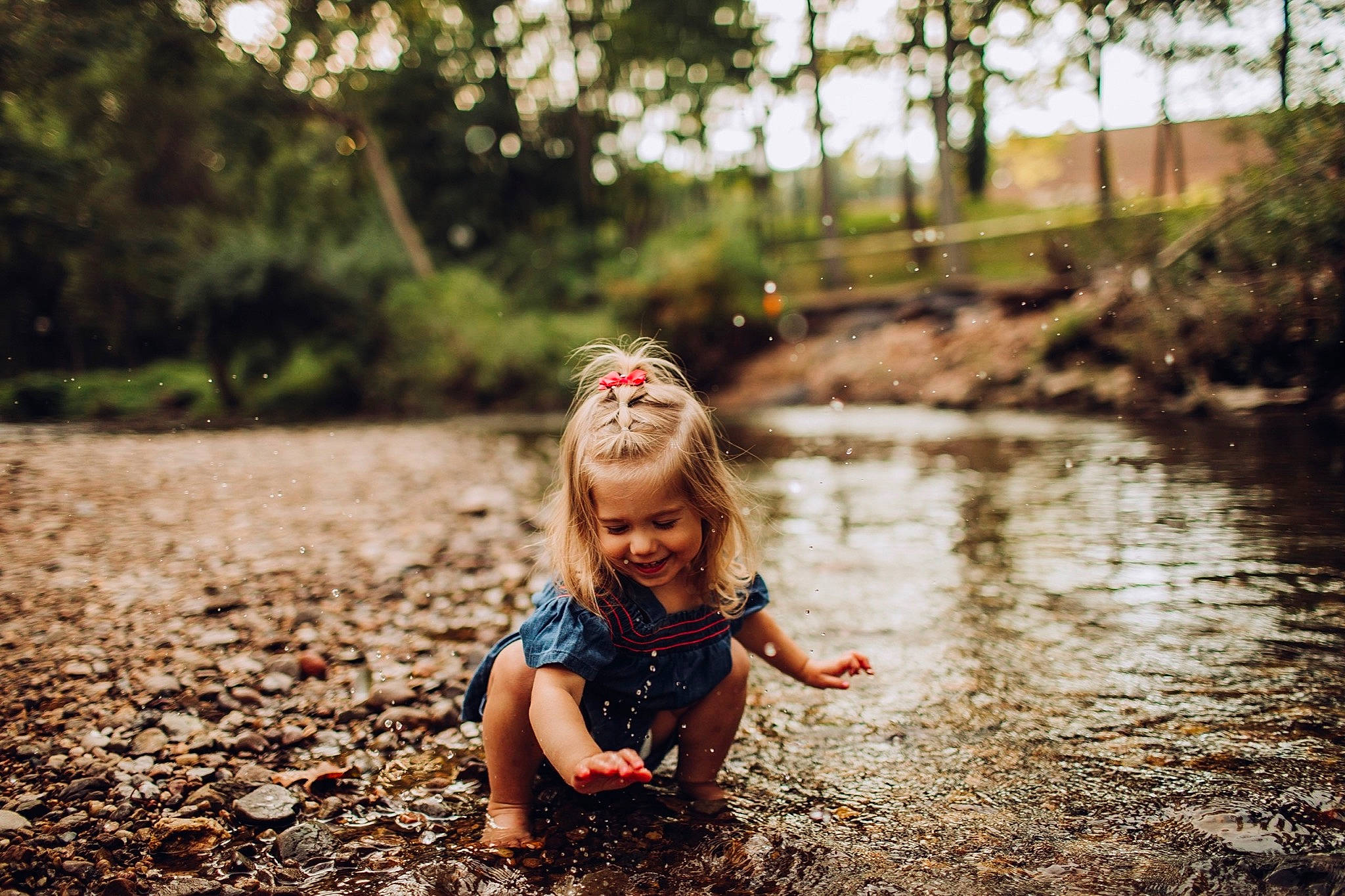 Blaire is registered to the contest to win money with this photo: bank, beauty, blond, child, forest, fun, joy, leaf, nature, people, people_in_nature, person, photograph, photography, play, smile, spring, summer, sunlight, toddler