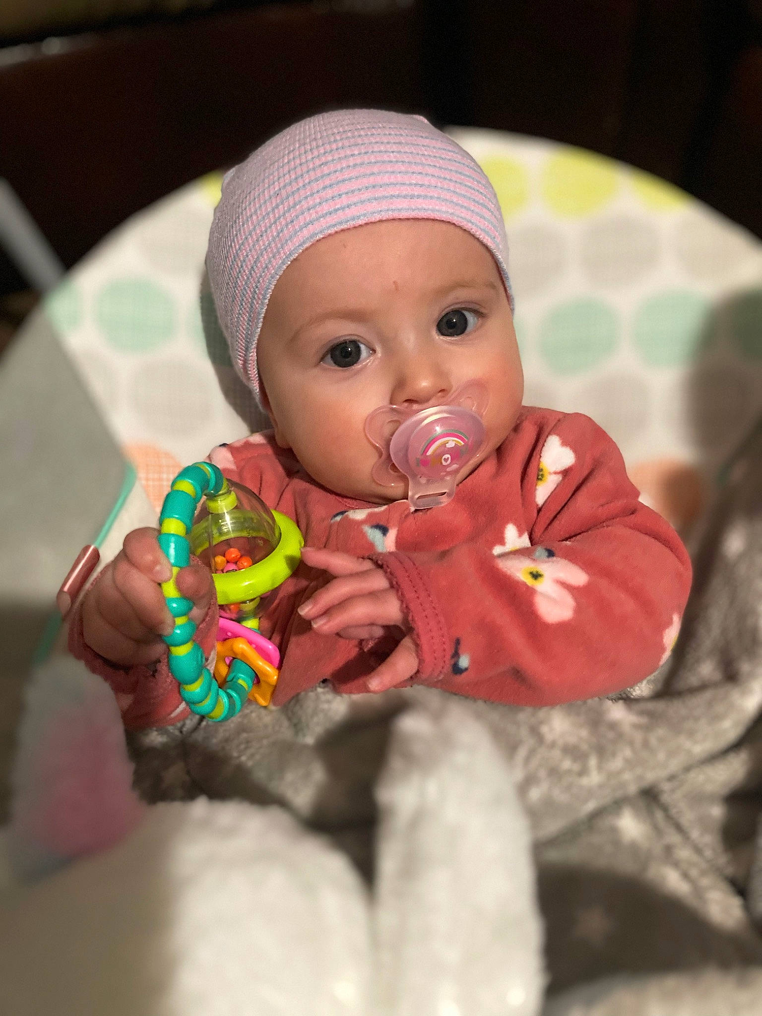 Olivia is registered to the contest to win money with this photo: baby, baby_products, baby_toddler_clothing, beanie, cap, carmine, cheek, child, christmas, fictional_character, happy, headwear, knit_cap, linens, lip, nail, person, sitting, sweetness, toddler