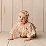 Joelle is registered to the contest to win money with this photo: baby, babycrawling, bodypart, clothing, crawling, dress, face, finger, hand, hardwood, head, newborn, person, photography, portrait, wood