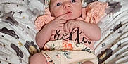 Wednesday is registered to the contest to win money with this photo: baby, blanket, child, clothing, cute, expression, feet, hands, headband, indoors, infant, lying_down, newborn, pastel_colors, pattern, portrait, sheep, sleepwear, soft_texture, young