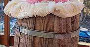 Wednesday joined the competition — help win amazing prizes! baby, baby_girl, background, barrel, child, cute, daylight, expression, face, fuzzy_blanket, happy, infant, nature, outdoor, pink_bow, pink_clothing, porch, smiling, wood, wooden_barrel