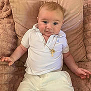 Tigran a rejoint le concours — aidez-le/la à gagner de superbes lots ! baby, child, infant, white_clothing, polo_shirt, gold_necklace, plush_blanket, decorative_pillow, couch, smiling, cute, portrait, indoors, relaxed, happy, person, young_child, sitting, skin, face