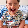 Isaac joined the competition — help win amazing prizes! baby, child, smiling, happy, crocodile_pattern, shirt, sitting, indoors, blanket, blue, cute, infant, portrait, skin, face, tooth, hair, hand, foot, couch