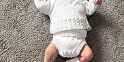 Albie joined the competition — help win amazing prizes! baby, bodypart, bonnet, cap, clothing, face, finger, footwear, hand, hat, head, hosiery, newborn, pants, person, photography, portrait, shoe, sitting, sock
