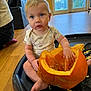 Albie joined the competition — help win amazing prizes! background, basketball_hoop, child, clothing, curious, eyes, face, floor, hand, indoor, orange, person, pumpkin, scooping, seeds, sitting, skin, toddler, tray, window
