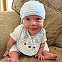 Albie joined the competition — help win amazing prizes! baby, beige, bib, blue_eyes, child, clothing, couch, cute, foot, hand, happy, hat, indoor, infant, patterned_fabric, person, portrait, sitting, smiling, striped_clothing