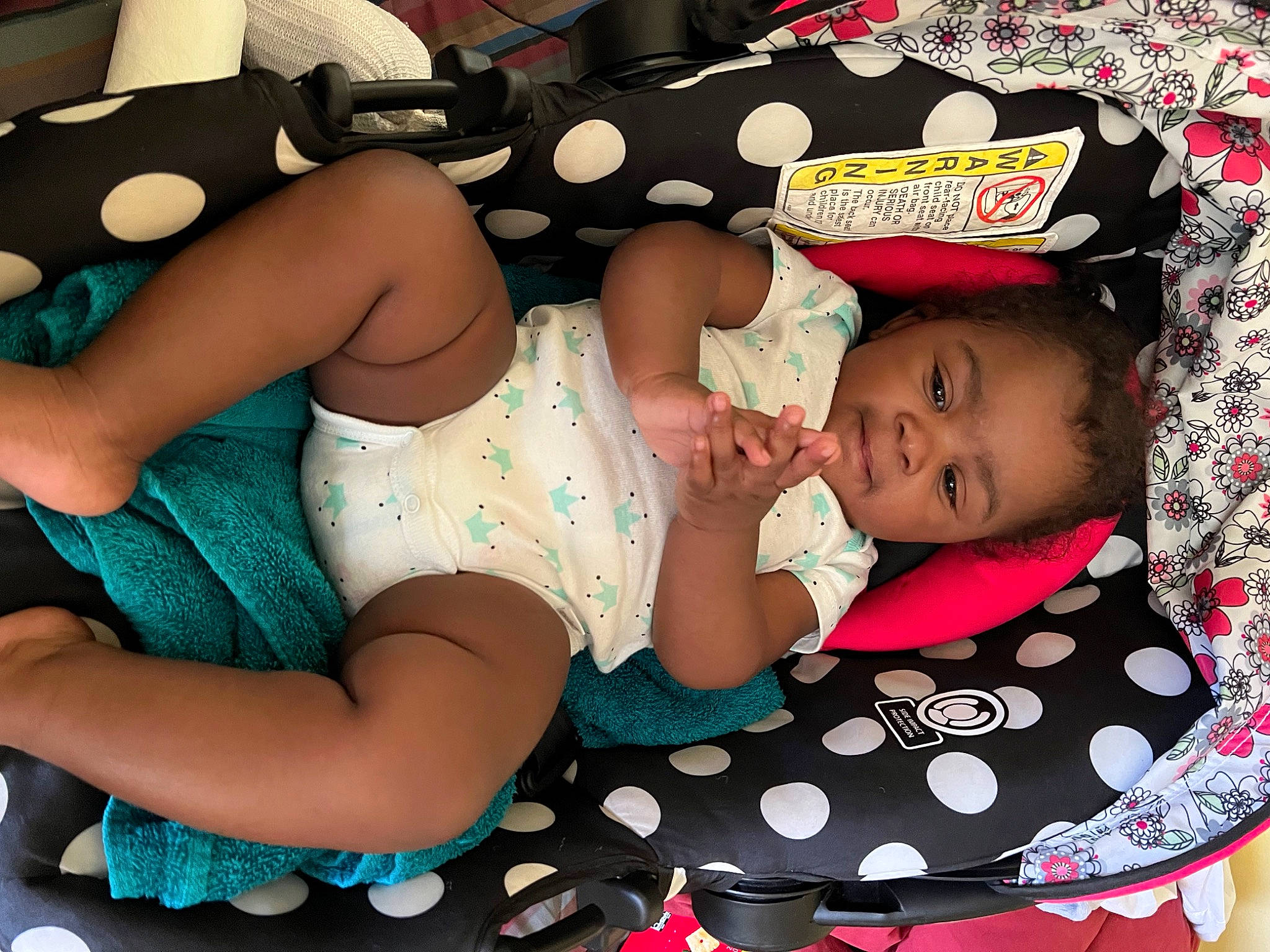 Adrianna is registered to the contest to win money with this photo: arm, baby, baby_toddler_clothing, child, comfort, cool, fashion_accessory, finger, hand, happy, human_leg, knee, pattern, person, photograph, pink, textile, thigh, toddler, white