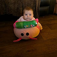 Marlie joined the competition — help win amazing prizes! baby, child, floor, plush_toy, snack_can, pringles, wooden_floor, pink, curious, indoors, furniture, couch, blanket, sitting, face, person, home, cozy, young_child, toy