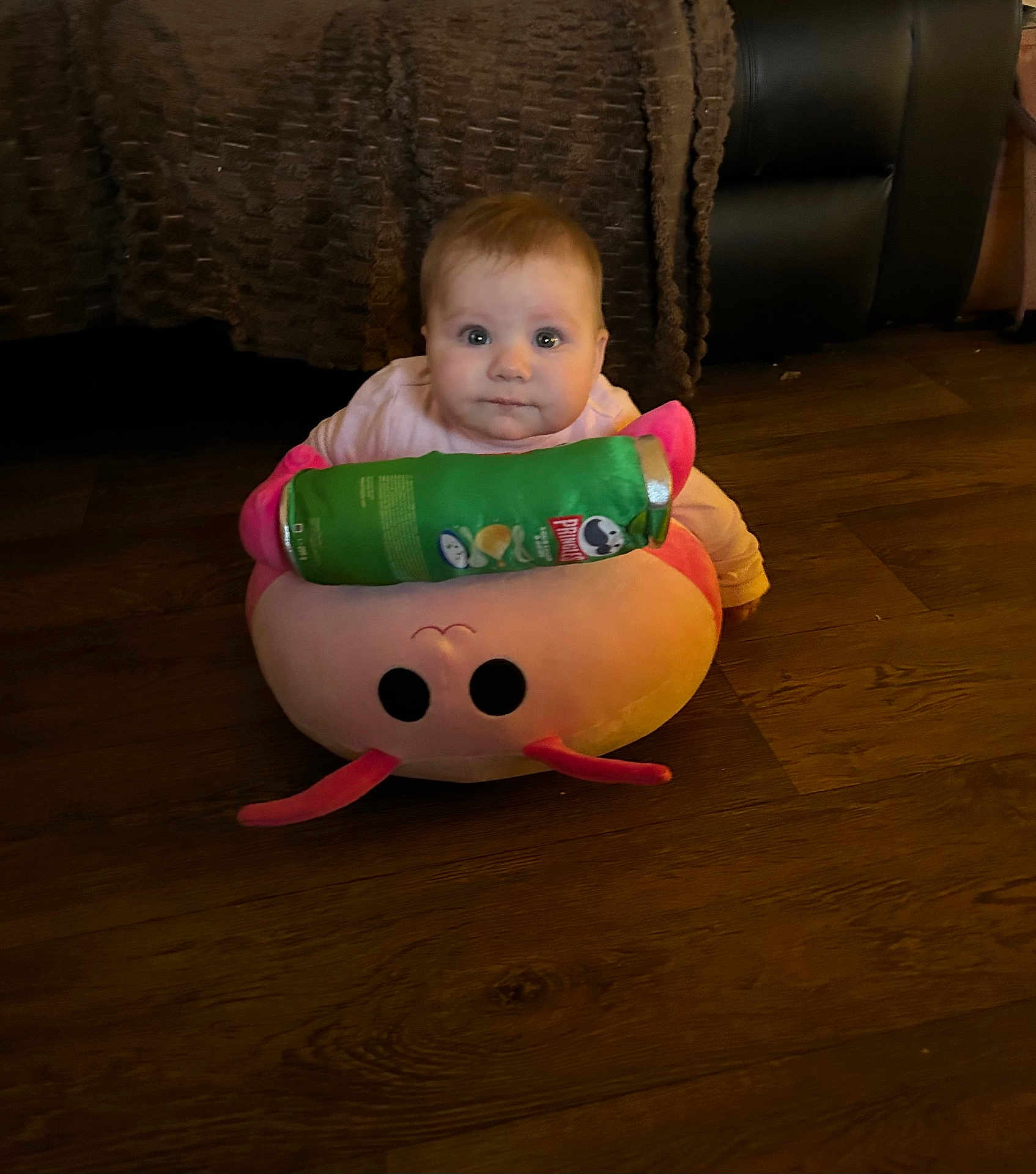 Marlie joined the competition — help win amazing prizes! baby, child, floor, plush_toy, snack_can, pringles, wooden_floor, pink, curious, indoors, furniture, couch, blanket, sitting, face, person, home, cozy, young_child, toy