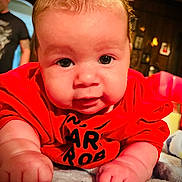 Ryder joined the competition — help win amazing prizes! baby, infant, child, red_shirt, face, hands, blanket, indoors, portrait, cute, chubby_cheeks, close_up, person, soft_lighting, carpet, expression, young_child, baby_face, toddler, warm_colors