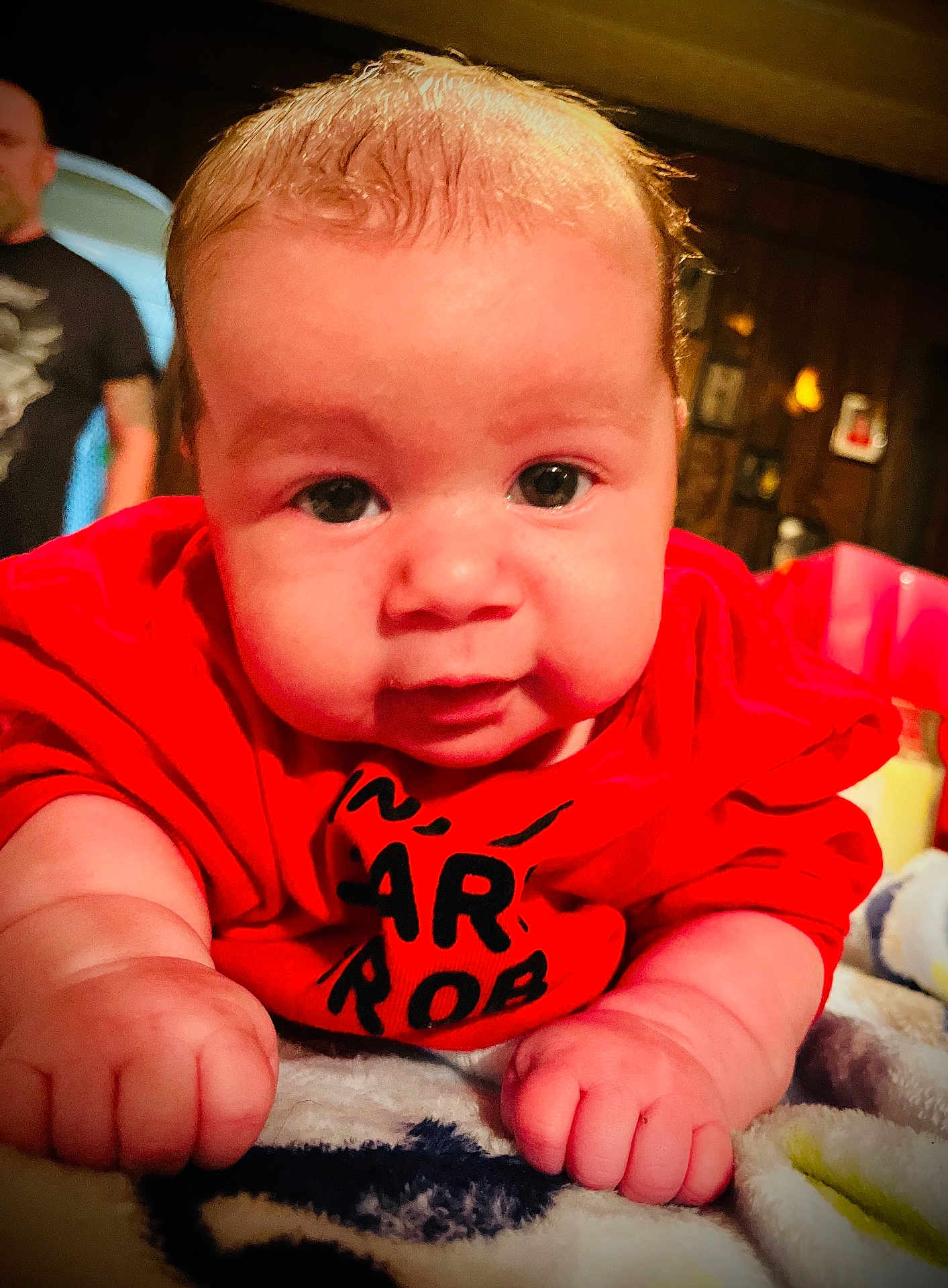 Ryder joined the competition — help win amazing prizes! baby, infant, child, red_shirt, face, hands, blanket, indoors, portrait, cute, chubby_cheeks, close_up, person, soft_lighting, carpet, expression, young_child, baby_face, toddler, warm_colors