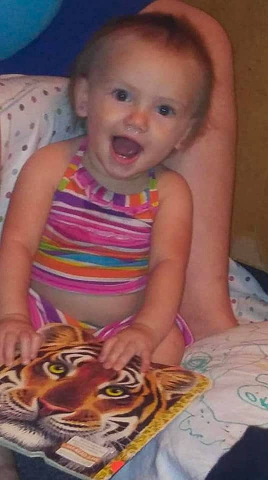 Beverly is registered to the contest to win money with this photo: baby, cheek, child, eye, face, finger, forehead, head, iris, mouth, nose, person, play, skin, smile, toddler, tummy_time