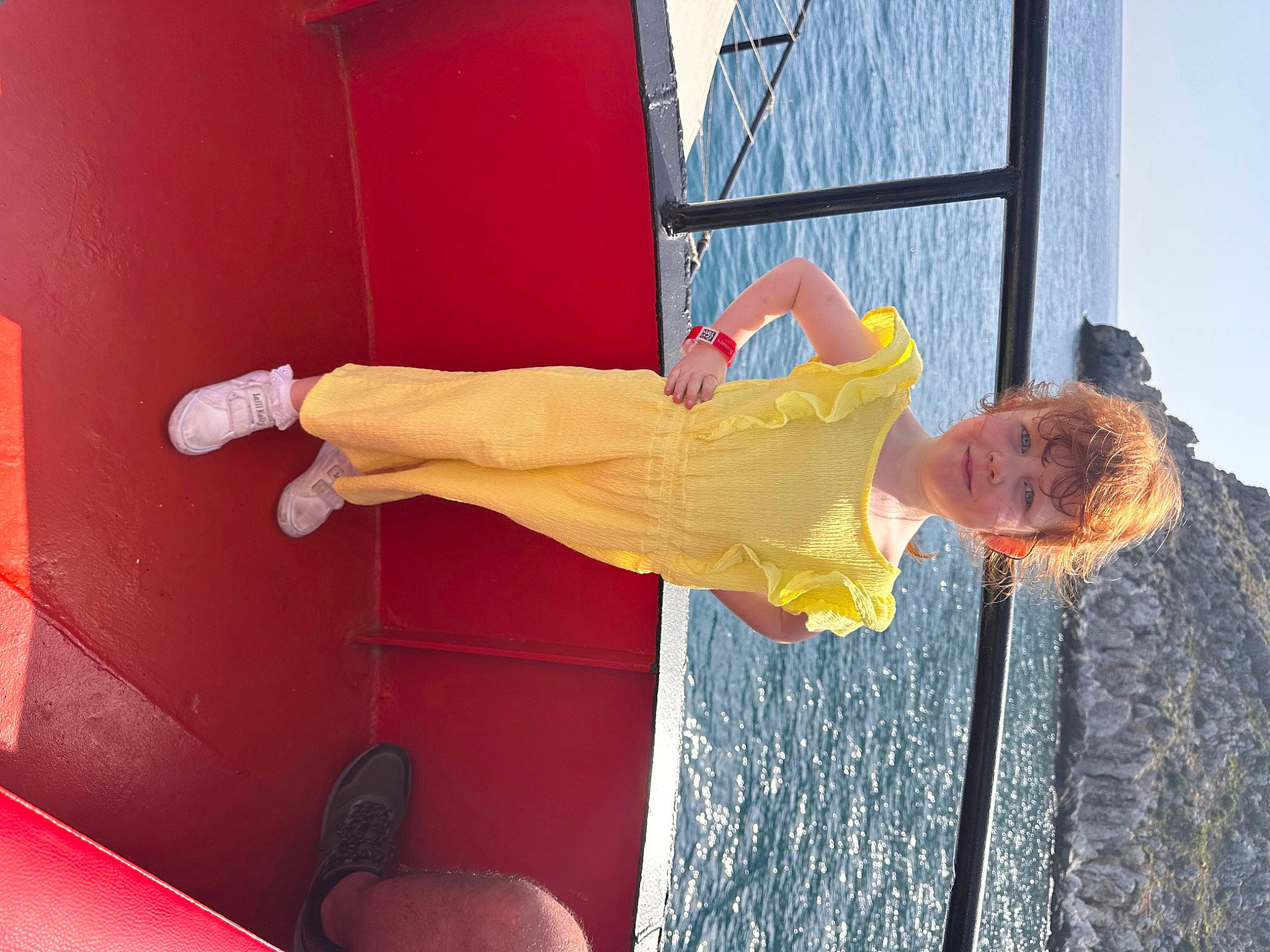 Ivy is registered to the contest to win money with this photo: balance, child, door, elbow, flooring, fun, happy, human_leg, knee, leisure, orange, person, sky, tire, vehicle_door, walking_shoe, water, wood