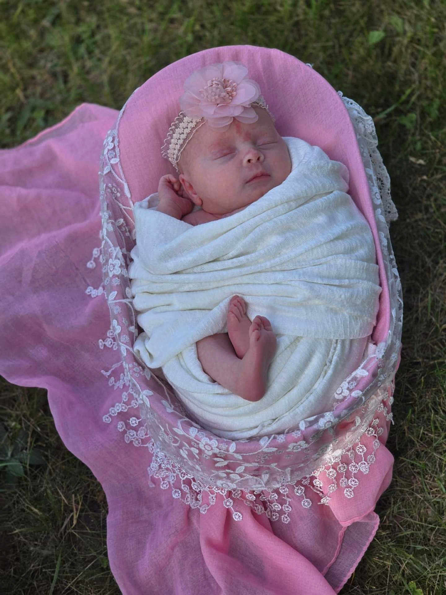 Rosemary is registered to the contest to win money with this photo: newborn, baby, sleeping, blanket, pink, headband, flower, basket, lace, grass, outdoor, wrapped, feet, peaceful, infant, soft, portrait, cute, resting, nature