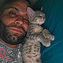 animal, beard, cat, closeup, collar, cozy, cuddle, face, happy, head, human, indoor, kitten, man, pet, portrait, relaxed, sleeping, snuggling, teal_background