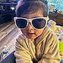 accessories, baby, bodypart, computerhardware, electronics, face, glasses, goggles, happy, hardware, head, monitor, person, photography, portrait, screen, sitting, smile, sphere, sunglasses