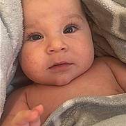 Andrew is registered to the contest to win money with this photo: baby, infant, blanket, soft, hand, face, skin, eyelashes, close_up, cute, child, portrait, newborn, cozy, warm, wrapped, expression, curious, indoors, person