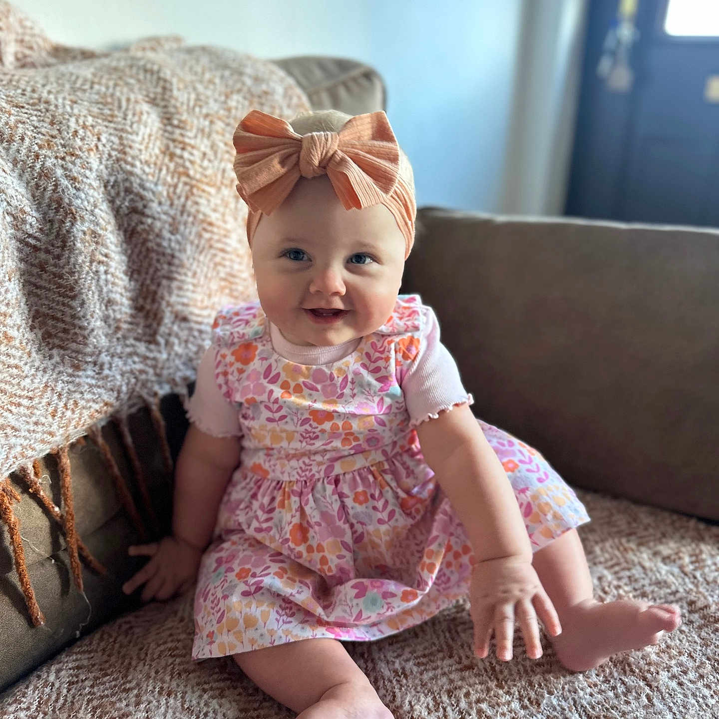 Autumn is registered to the contest to win money with this photo: baby, babylaughing, bed, bedroom, clothing, couch, cushion, dress, face, furniture, happy, head, homedecor, indoors, person, photography, portrait, room, sitting, smile