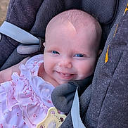 Lily is registered to the contest to win money with this photo: baby, infant, smiling, blue_eyes, pink_dress, pacifier, car_seat, maxi_cosi, child, cute, happy, outdoor, closeup, portrait, seatbelt, clothing, head_support, skin, face, small_hand
