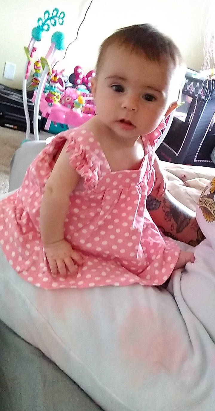 Olivia joined the competition — help win amazing prizes! baby, baby_products, baby_toddler_clothing, chair, cheek, child, comfort, dress, eye, face, finger, hairstyle, magenta, pattern, person, pink, sitting, skin, sleeve, t_shirt