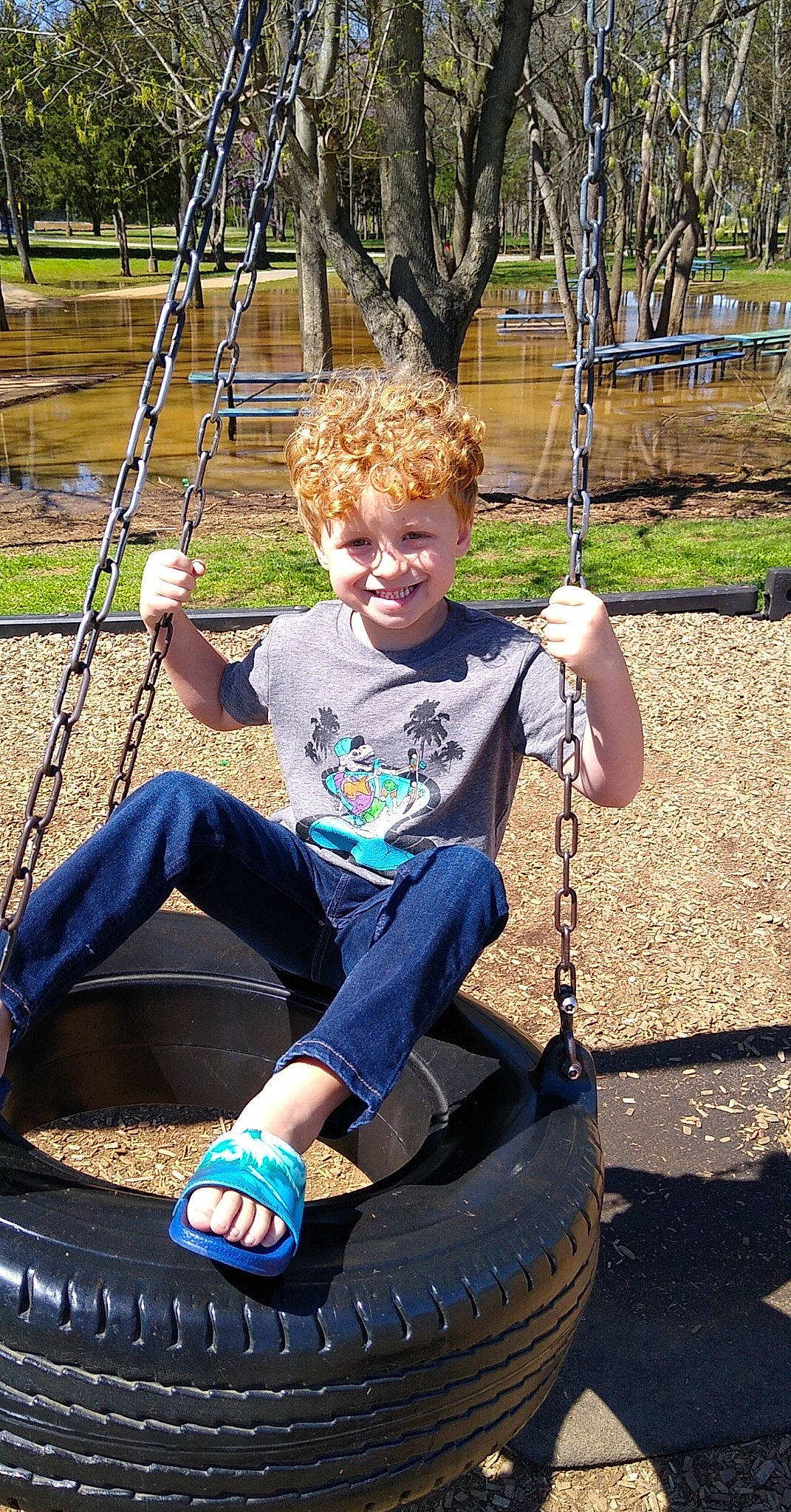 Coleton joined the competition — help win amazing prizes! arm, automotive_tire, black, blue, grass, green, human_body, joy, light, nature, person, photograph, plant, playground, smile, swing, tire, tread, tree, wheel