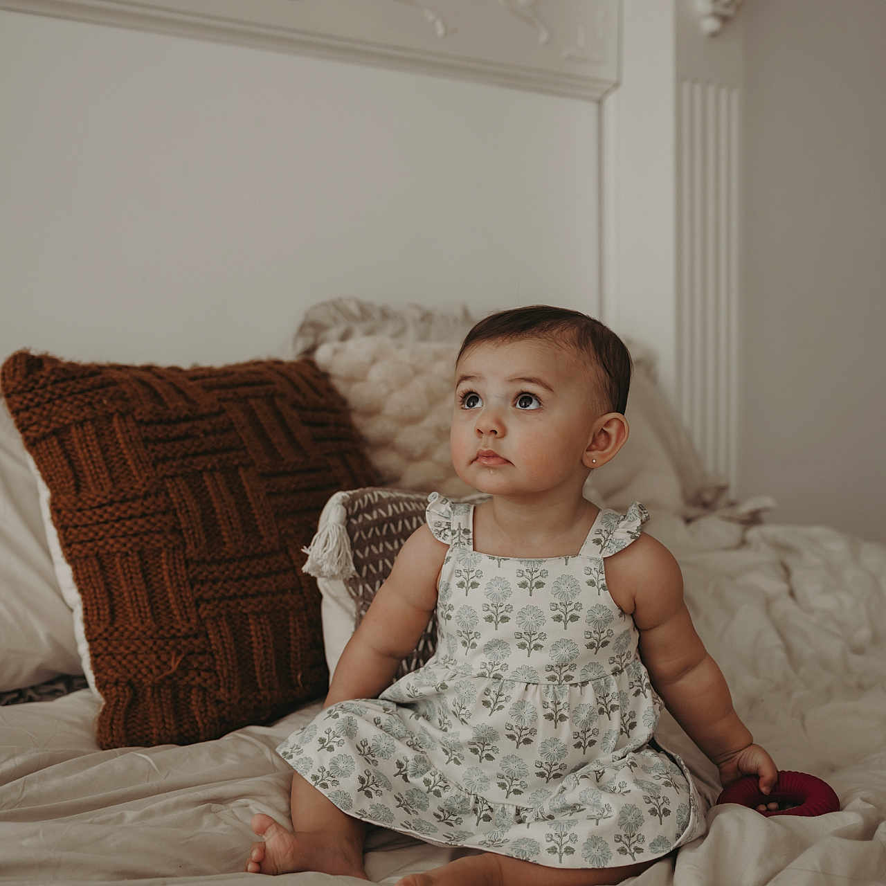 Alessa joined the competition — help win amazing prizes! baby, barefoot, bed, child, cozy, curly_hair, cute, dress, furniture, home, indoors, infant, looking_up, person, pillow, sitting, skin, soft_light, toddler, toy