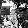 baby, child, easter_eggs, plush_toy, headband, outdoor, grass, trees, dog, basket, black_and_white, cute, sitting, nature, sunlight, playful, portrait, infant, toy, spring