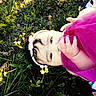 baby, child, grass, flower, headband, pink_dress, hand, nature, outdoor, young_child, infant, greenery, sunlight, closeup, playful, toddler, portrait, person, cute, summer
