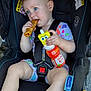 Aurora is registered to the contest to win money with this photo: baby, blue_eyes, bottle, car_seat, child, clothing, curious, cute, daylight, earring, food, outdoor, person, plastic_bottle, seatbelt, sitting, snack, spongebob, toddler, toy