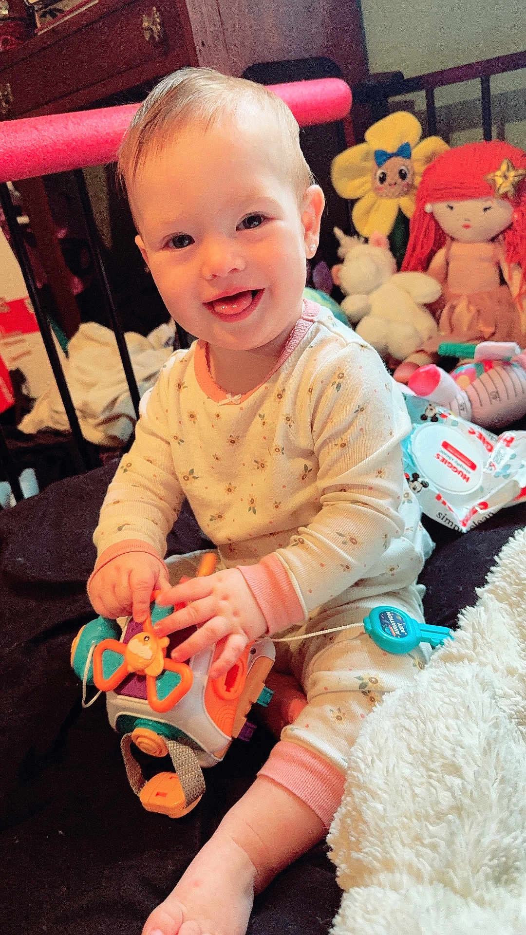 Aurora is registered to the contest to win money with this photo: baby, baby_wipes, bed, blanket, child, cute, face, foot, furniture, hands, happy, indoor, infant, pajamas, playing, plush_doll, room, smiling, toy, unicorn_toy