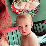 Aurora is registered to the contest to win money with this photo: baby, bed, bedroom, child, curious, earrings, hammock, holding, home, indoor, light, person, pigtails, playful, shirtless, soft_light, stuffed_animals, toddler, toy, young_child