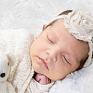 Luna joined the competition — help win amazing prizes! baby, sleeping, headband, flower, pearl, knit_blanket, teddy_bear, soft_toy, cozy, infant, cute, peaceful, closeup, portrait, newborn, child, face, hand, resting, white_background