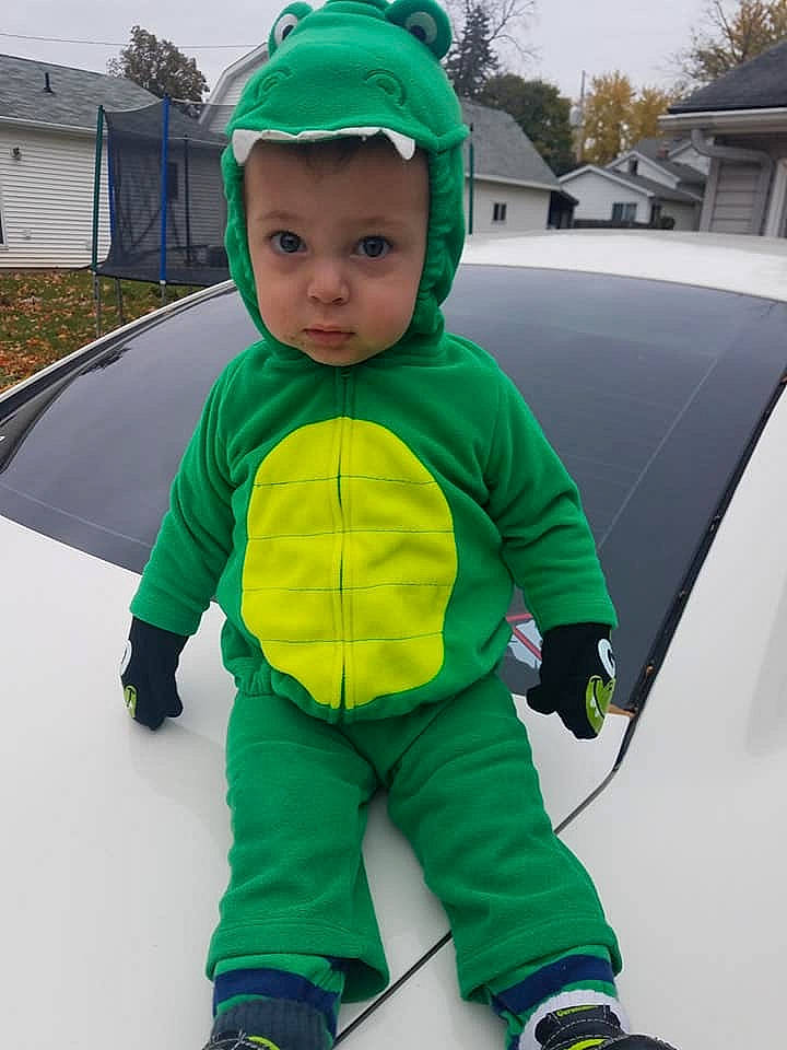 Brantley is registered to the contest to win money with this photo: child, costume, fictional_character, green, hood, hoodie, jacket, outerwear, person, personal_protective_equipment, plant, play, recreation, sleeve, snow, toddler, winter