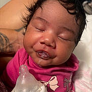Kayali is registered to the contest to win money with this photo: baby, infant, sleeping, dribble, bottle, pink_clothing, cute, face, portrait, child, hand, skin, hair, mouth, expression, indoors, closeup, person, newborn, resting